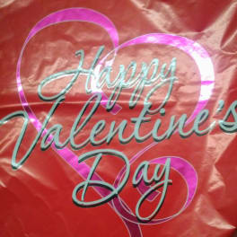 Red Valentine’s Day balloon with heart graphics and text