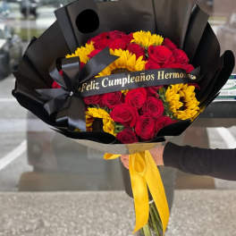 Bouquet of red roses and yellow sunflowers wrapped in black paper