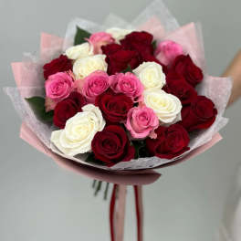 Bouquet of red, pink, and white roses wrapped in pink paper