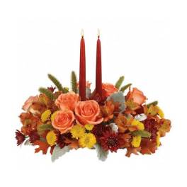 Autumn floral centerpiece with two red taper candles