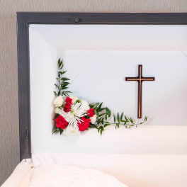 White and red floral casket spray with a cross