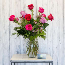 Pink and red roses in a clear glass vase