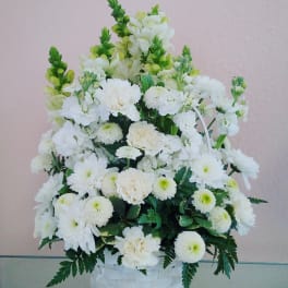 White floral basket arrangement with daisies and carnations