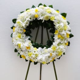 White and yellow floral wreath on a standing easel