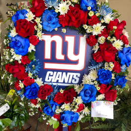 Large floral wreath around a New York Giants sign with red and blue roses