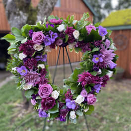 Heart-shaped floral wreath with purple and white blooms
