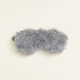 Gray fuzzy plush eye mask on a light background