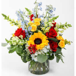 Mixed bouquet with red and yellow roses in a glass vase