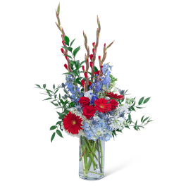 Red and blue mixed bouquet in a clear glass vase