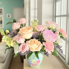 Pastel rose bouquet in a painted ceramic vase