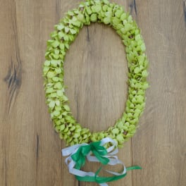 Green floral lei with white and green ribbon ties