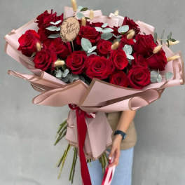 Bouquet of red roses with pale eucalyptus and pink wrapping