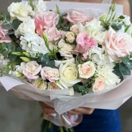 Hand-tied bouquet of pale pink and white roses with white blooms