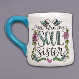 White mug with blue handle and floral "Soul Sister" text