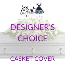 White casket cover with a large floral spray and purple text.