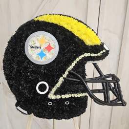 Football helmet-shaped floral tribute in black, yellow, and white