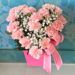 Pink carnation bouquet in a bright pink box with a ribbon bow