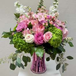 Pink and white mixed flower arrangement in a metallic vase