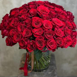Large bouquet of red roses in a glass vase