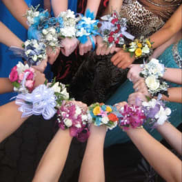 Group of floral wrist corsages in assorted colors held together