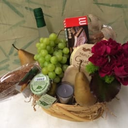 Gift basket with roses, grapes, pears, chocolate, and a candle
