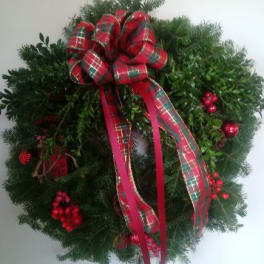 Christmas wreath with red plaid bow and ribbon