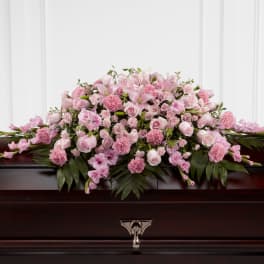 Pink floral casket spray with roses and lilies