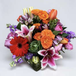 Mixed bouquet with orange roses, lilies, and a red gerbera daisy