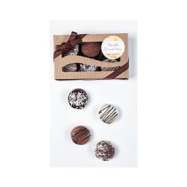 Gift box of assorted chocolate-covered cookies with four cookies arranged below on a white background.