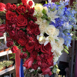 Large bouquet of red, white, and blue flowers on a stand