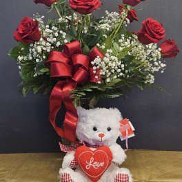 Red roses with baby's breath and a teddy bear holding a heart