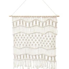 Cream macramé wall hanging with a wooden dowel and hanging cord