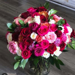 Bouquet of multicolored roses in a clear glass vase