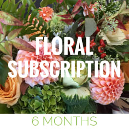 Mixed bouquet with peach and pink flowers and greenery, overlaid with subscription text