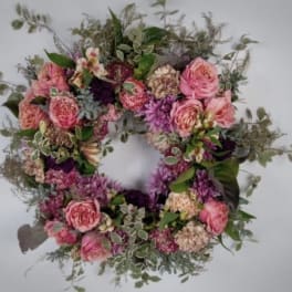 Pink and purple floral wreath with roses and mixed blooms