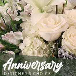 Arrangement of white roses, lilies, hydrangeas, and alstroemeria with Anniversary text overlay