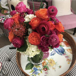 Bouquet of pink and orange flowers in a glass vase