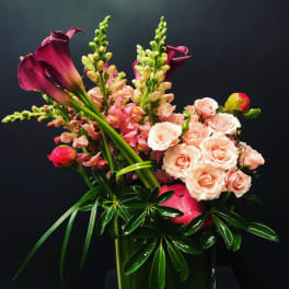 Bouquet with pink calla lilies, peach roses, and snapdragons