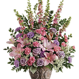 Pink and lavender floral arrangement in a decorative vase