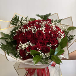 Bouquet of red roses with white baby's breath and greenery