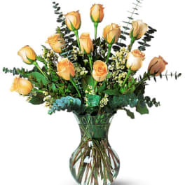 Peach roses arranged in a clear glass vase