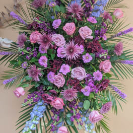 Large standing floral spray with pink roses and purple blooms