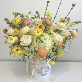 Mixed pastel bouquet in a white hatbox with a ribbon