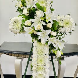 White floral standing spray with lilies, roses, and chrysanthemums