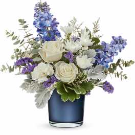 White roses and purple-blue flowers in a dark blue vase