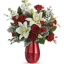 Red roses and white lilies in a red vase