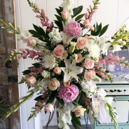 Tall pastel floral standing spray with pink roses and white lilies