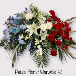 Red, white, and blue floral spray with roses and lilies