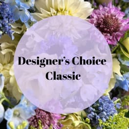 Designer’s Choice Classic floral arrangement with blue, purple, and cream blooms