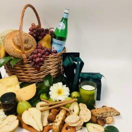 Gift basket with fruit, bread, cheese, crackers, and a candle
